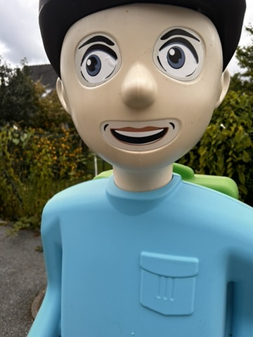 A plastic toy figure with a cartoon face

Description automatically generated
