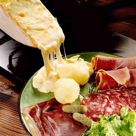 Cheese on a plate with meat and vegetables

Description automatically generated